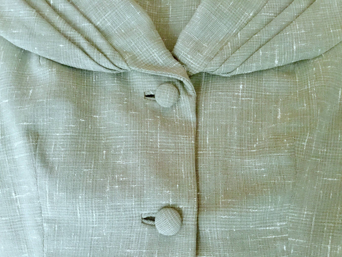 Close-up of fabric, self-covered buttons and collar detail