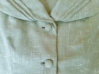 Close-up of fabric, self-covered buttons and collar detail