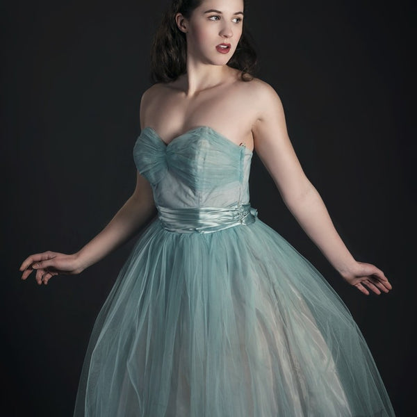 young woman wearing light blue vintage party dress