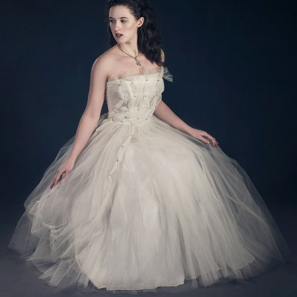 young woman wearing white tulle vintage party or wedding dress