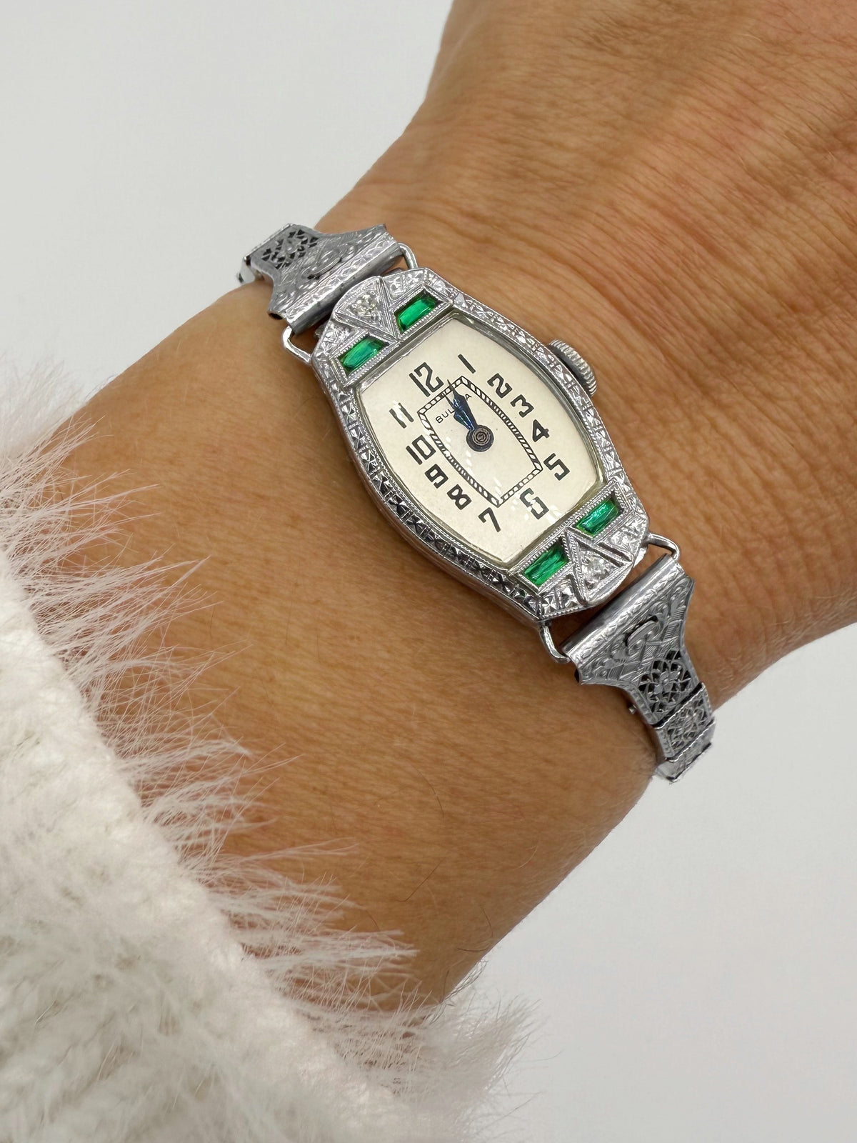 1928 Bulova Art Deco ladies watch in 14K white gold with diamonds and emeralds on a wrist