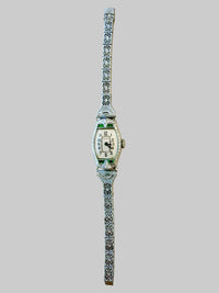 Decorative 1920s Bulova wristwatch with intricate band design on a white background