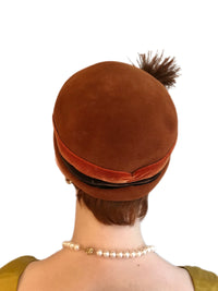 Model wearing midcentury Schiaparelli Paris vintage feather pom hat, back view
