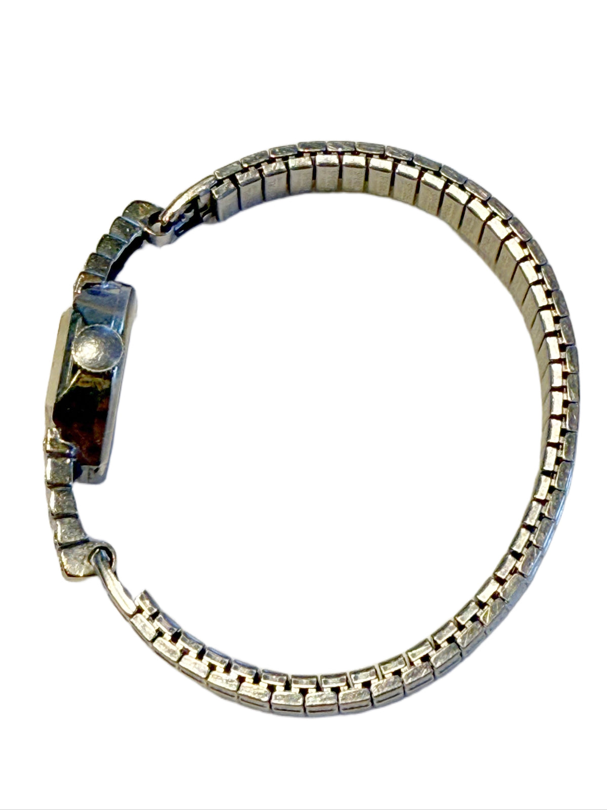 Side view of Art Deco stepped diamond shoulders on 14K white gold Benrus wristwatch and flexible stainless steel bracelet.