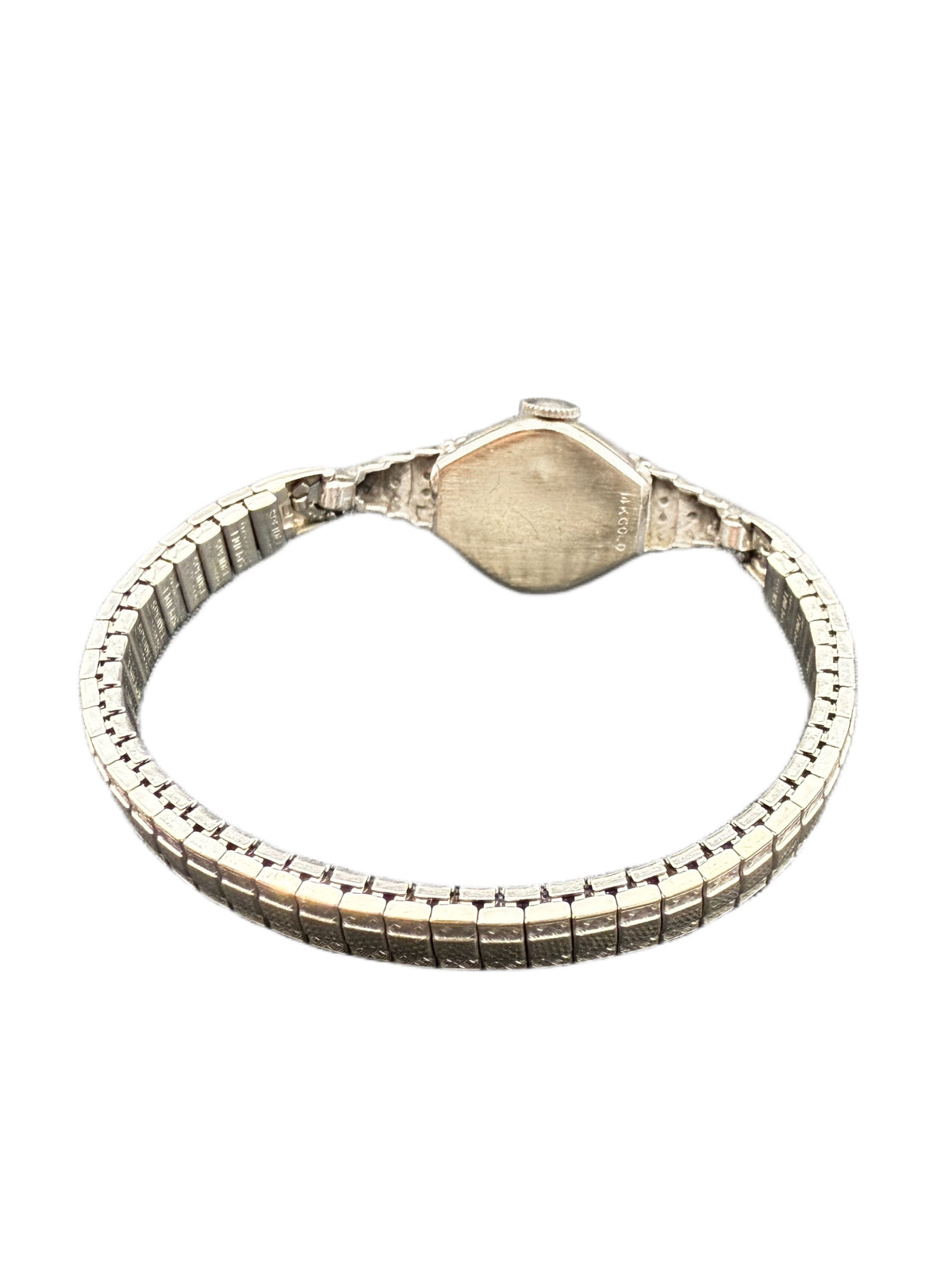 Back view of Art Deco stepped diamond shoulders on white gold Benrus wristwatch, showing 14K GOLD stamp on caseback.