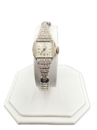 1930s Benrus Art Deco ladies wristwatch in solid 14K white gold with stepped diamond-set shoulders on a watch stand.