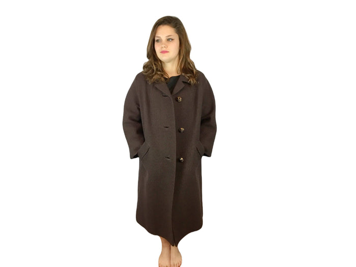 Front view of model wearing unbuttoned coat