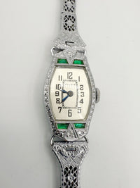 Close-up view; face of 1928 Bulova Art Deco ladies watch in 14K white gold with diamonds and emeralds