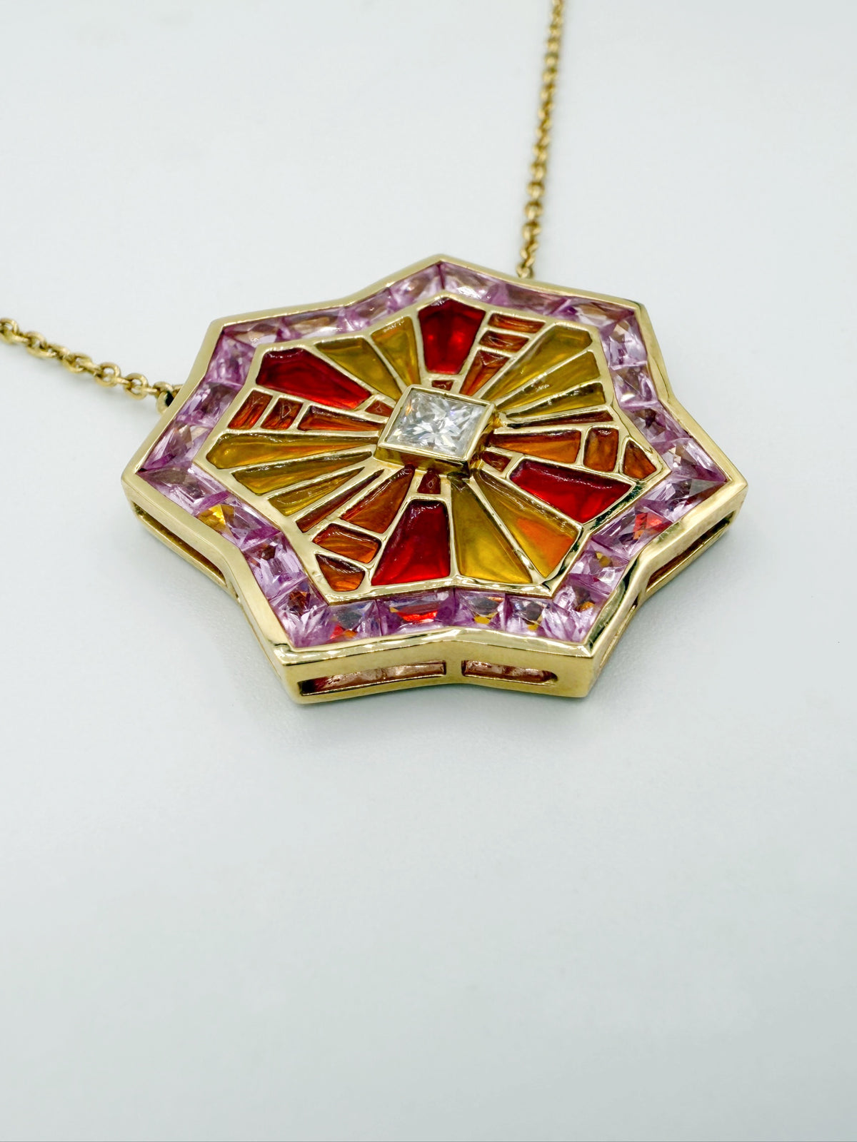 Close-up of plique-à-jour enamel sunrise motif on ARK OM pendant