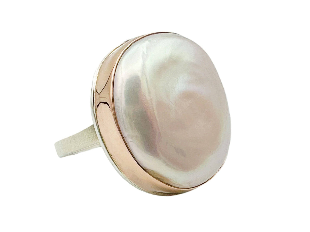 Close-up side angle of ring showing luster of pearl and highly polished rose gold bevel