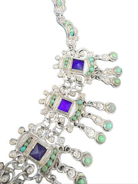 Close-up of Matl amethysts, turquoise, and ornate scrollwork in hand-wrought sterling silver