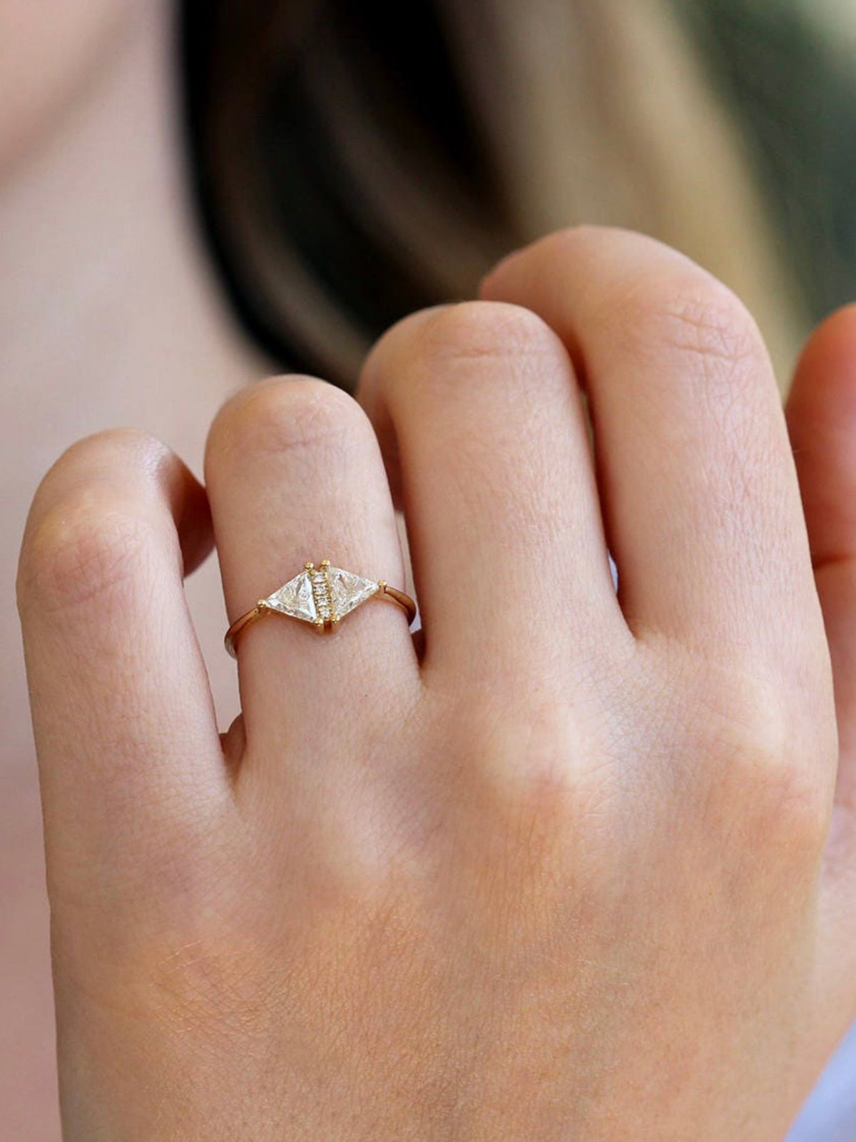 Triangle diamond Art Deco ring in 18k gold shown on hand for scale.