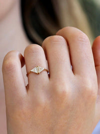 Triangle diamond Art Deco ring in 18k gold shown on hand for scale.