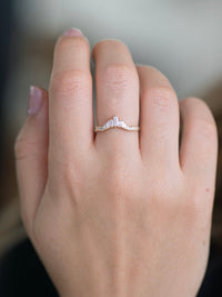 Hand wearing Artemer tiara-style baguette diamond ring in yellow gold