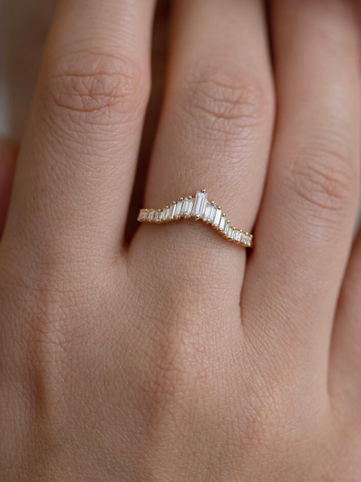 Baguette diamond stacking ring in 18K yellow gold with tapered design on hand
