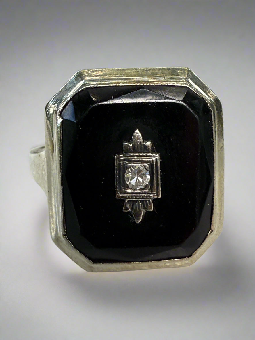 Diamond ring with black stone on a white surface