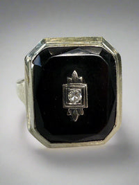 Diamond ring with black stone on a white surface