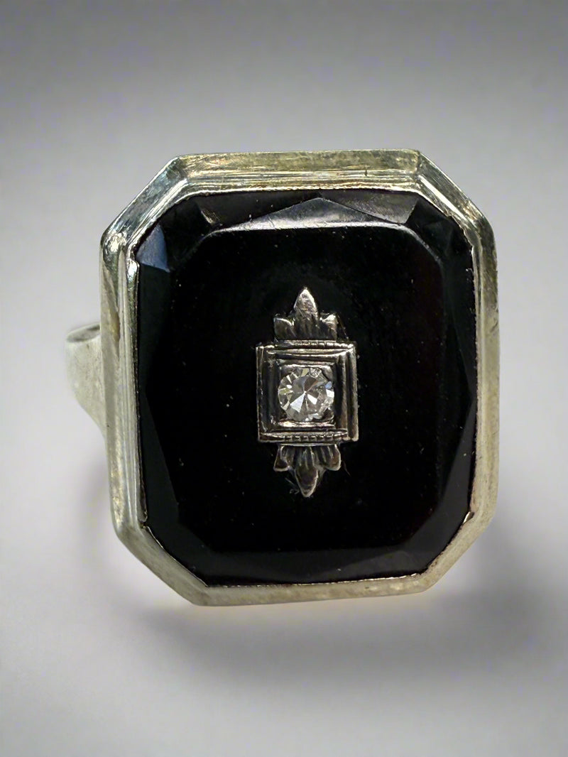 Diamond ring with black stone on a white surface