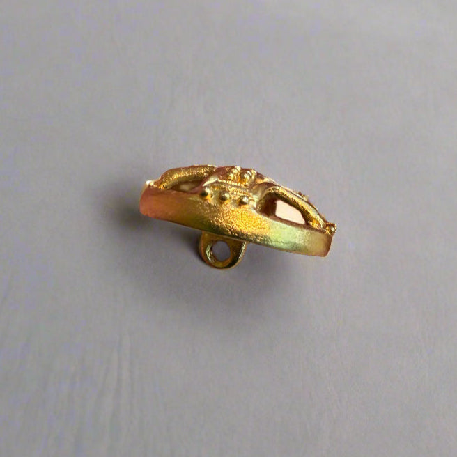 Gold button held by a hand. background.