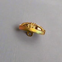 Gold button held by a hand. background.