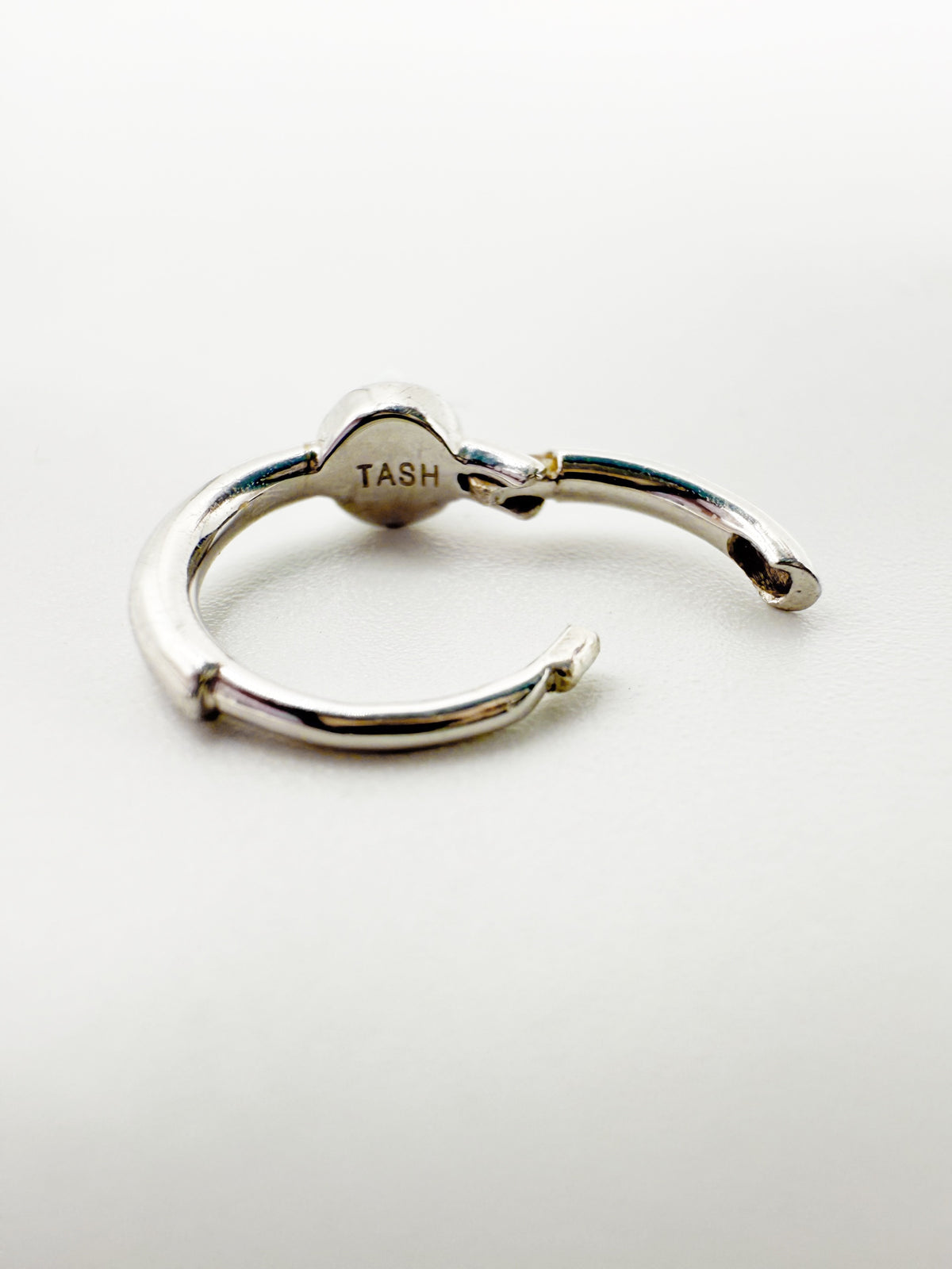 TASH hallmark visible to the verso of Maria Tash 14k white gold hoop huggie