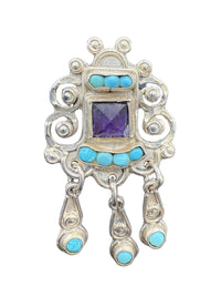 Alt earring close-up of Matl scrollwork with turquoise and amethyst stones