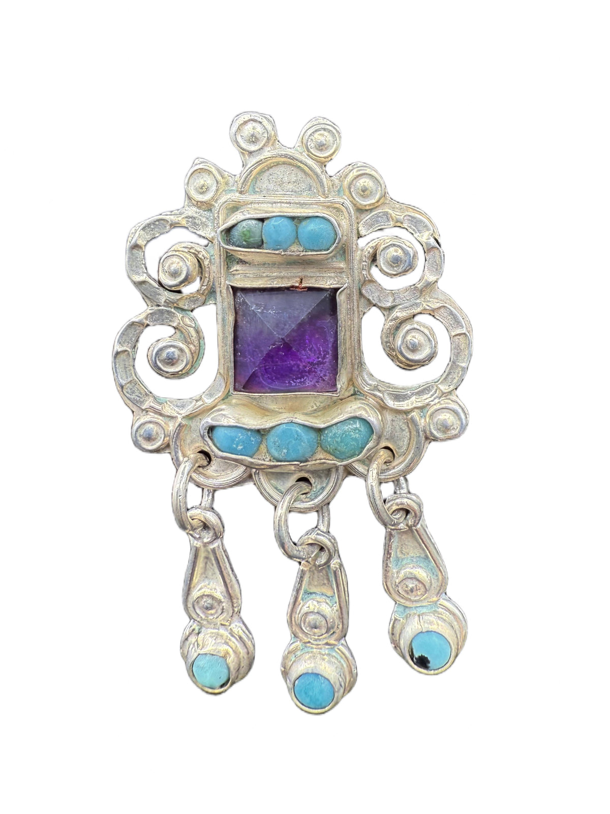 Close-up of Matl scrollwork with turquoise and amethyst stones