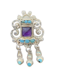 Close-up of Matl scrollwork with turquoise and amethyst stones