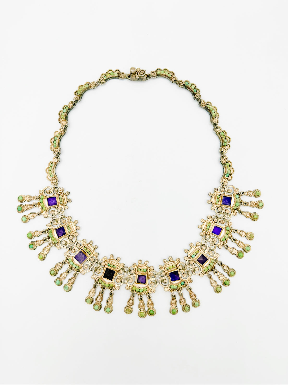 Matl sterling silver necklace laid flat with articulated gemstone fringe