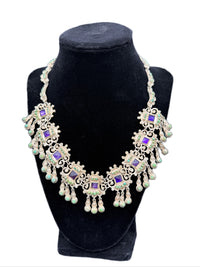 Vintage Matl sterling silver necklace with amethyst and turquoise fringe displayed on a mannequin bust.