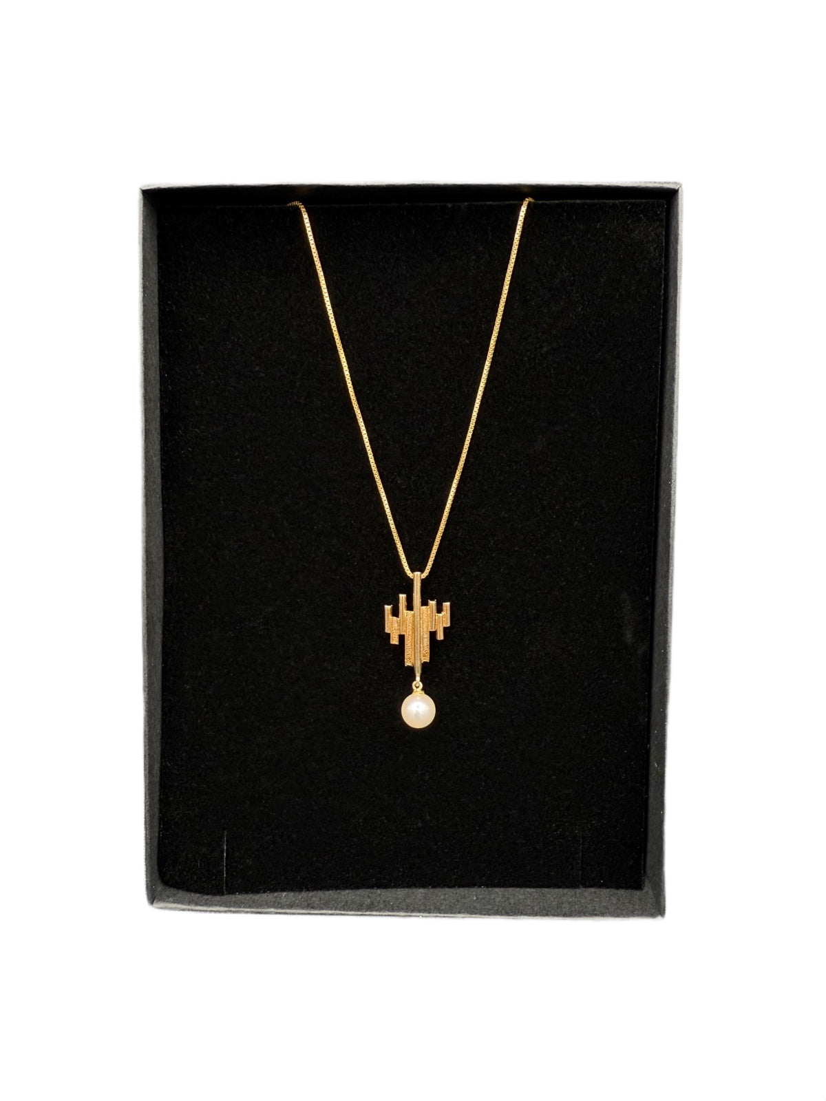 Minimalist 14K gold vintage necklace with sculptural pendant and 6.3mm pearl shown in gift box.