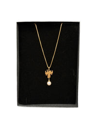 Minimalist 14K gold vintage necklace with sculptural pendant and 6.3mm pearl shown in gift box.
