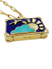 Close-up bottom view of NeverNot Dreamy Night pendant showing dimensionality of turquoise cloud, gold airplane, mother of pearl sun, diamond corners and suitcase detailing. NNT 14K hallmarks visible. 