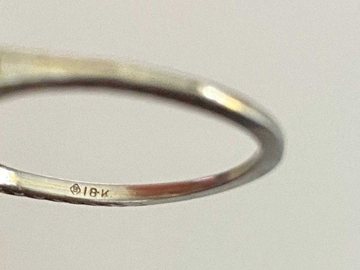Close-up of maker's mark and 18K stamp